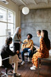 © BONNINSTUDIO/Stocksy - Diverse colleagues discussing project during meeting