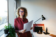 © BONNINSTUDIO/Stocksy - Dreamy freelancer looking out window
