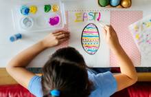 Little Girl Drawing Easter Eggs