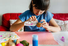 Little Girl Decorating Easter Eggs
