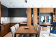 © ALEKSANDAR NOVOSELSKI/Stocksy - Modern kitchen and dining room in contemporary interior