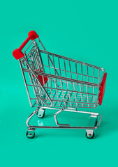 Wall Mural - Toy shopping cart on green