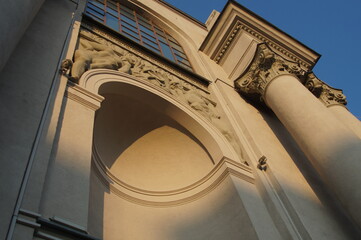 Photo of a fragment of the facade of a historic building with elements of classical architecture. Natural light on a Sunny evening.