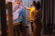 © DC Studio - Young man learning to paint on canvas from successful painter. Modern artwork paint on canvas, creative, contemporary and successful fine art artist drawing masterpiece