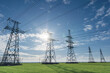 © yelantsevv - Electrical net of poles on a panorama of blue sky and green meadow