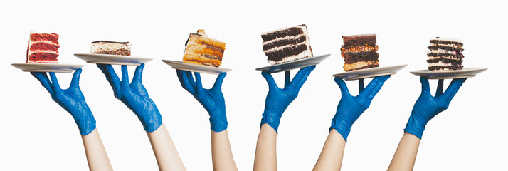 Many plates with pieces of different cakes in the hands of the waiters who lifted them up. A place for your text