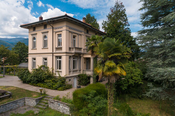 Ancient villa surrounded by nature in the hills in Switzerland. Sunny summer day