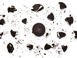 Sticker - Sandwich chocolate cookies with a sweet cream with crumbs isolated on white background.