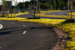 © Trygve - Curvy bike and walking path aling a road.