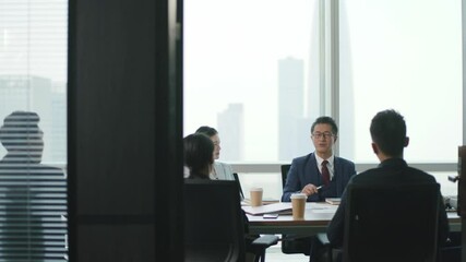 Wall Mural - group of asian corporate executives meeting in company conference room discussing business