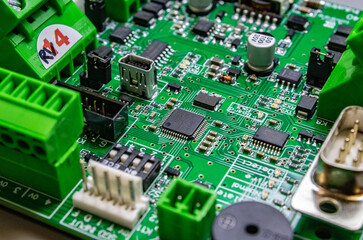 Wall Mural - green circuitboard with microcontroller in centre of small city