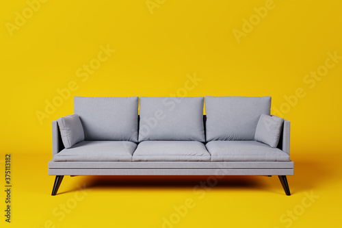 Grey couch with pillows on studio yellow background. Tableau sur Toile