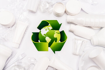 Wall Mural - top view of recycle sign and plastic rubbish scattered on white background