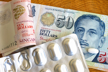 Singaporean dollars and medicinal pills.