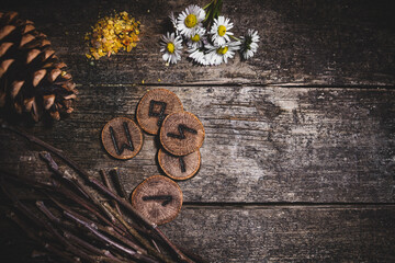 Flatlay of naturally background with futhark or elder runes, reading and fortune