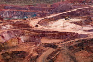 Wall Mural - Color aluminium ore quarry. Bauxite clay open cast (open cut) mining. Quarry steps. Dump (quarry) trucks and excavator.