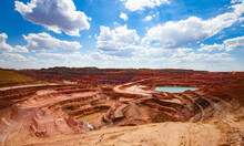Aluminium Ore Quarry And Blue Lake In Bauxite Clay Mine. Open Cast (open-cut) Mining. Panorama View. Blue Sky With Clouds In Summer Day.