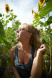 © Naz - Blonde woman in sunglasses  isolated on field with sunflowers