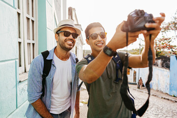 Wall Mural - Two happy male tourists taking self portrait. Travel and love concept in Latin America