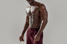 Cropped Shot Of Muscular African American Man Showing His Naked Torso While Posing Shirtless Isolated Over Grey Background. Sports, Workout, Bodybuilding Concept