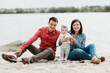 © Andriy Medvediuk - happy family resting by the lake. family with a small child