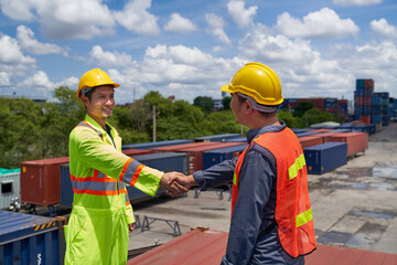 Two foreman shake-hand on box container in cargo site