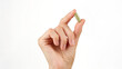 female hand holds in fingers capsule superfoods mooring or spirulina 