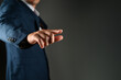 © SYARGEENKA - man in suit pointing his finger at you and the camera, isolated on dark background. Choice concept