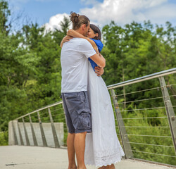 Sticker - Young couple kissing on background of a bridge