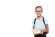 excited schoolkid in glasses holding books while looking at camera isolated on white