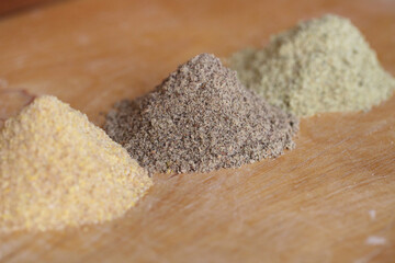 Various types of flour on wooden brown table