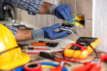 Wall Mural - Electrician at work with safety equipment on a residential electrical system. Electricity.