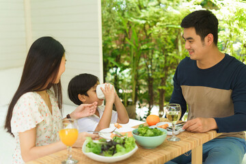 Asian family having lunch together at home.