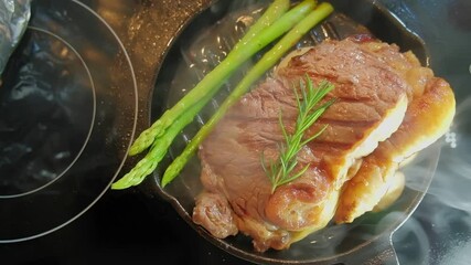 Poster - Cooking Searing fresh juicy slices of meat steak pork beef on iron pan with ingredients spices salt pepper garlic rosemary asparagus 