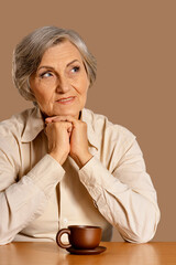 Sticker - Portrait of happy senior woman at table