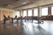 © VISUALSPECTRUM/Stocksy - Yoga Class in Urban Yoga Studio