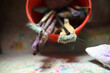 © Carolyn Lagattuta/Stocksy - Paint brushes in a bucket in the sink
