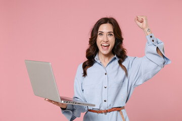 happy young brunette woman 20s wearing casual blue shirt dress posing working on laptop pc computer 