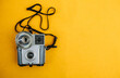 © kkgas/Stocksy - Vintage camera on a yellow background.
