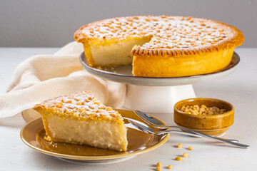 Wall Mural - A piece of Custard cream cake with pine nuts. Traditional italian cake - torta della nonna or grandmother's cake. Tuscany pastry.