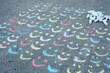 © Carolyn Lagattuta/Stocksy - Tons of chalk smiles and one frown on the driveway