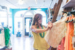 © SKC/Stocksy - Woman Shops for Clothes at a Fashionable Retail Boutique