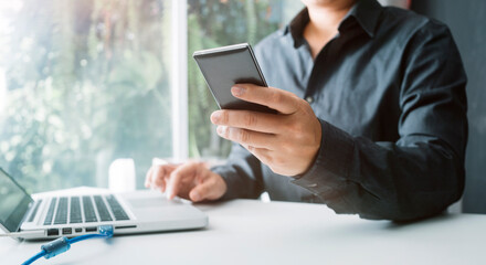 Digital marketing media in virtual screen.businesswoman hand working with mobile phone and modern compute with VR icon diagram at office in morning light