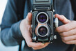 © Michela Ravasio/Stocksy - Man holding an old camera.