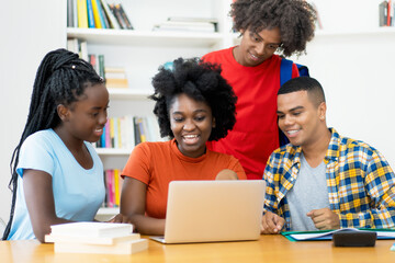 Group of african american and latin students working and learning at computer