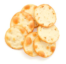 A Stack Of Cheesy Rice Crackers On A White Background.