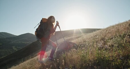 young redhead girl hiking in mountains. young beautiful woman backpacking in gorgeous landscapes, fi