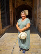 A Mature, plump woman walks through the streets of the old city.
