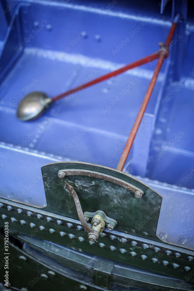 Cut through view of a float and needle gauge of a tender steam locomotive tank with water. Detail of mechanism to show the amount of water in the tank of a steam locomotive.