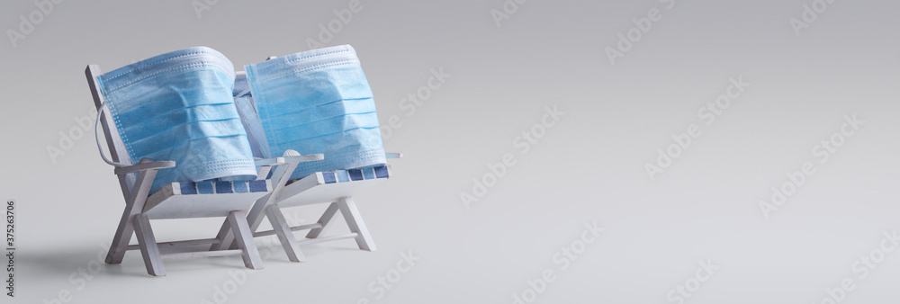 Pair of beach chairs with Coronavirus on vacation - obrazy, fototapety, plakaty 